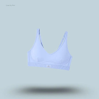 Alo Airlift Line Up Bra in Light Provence Blue, flat lay on light blue background