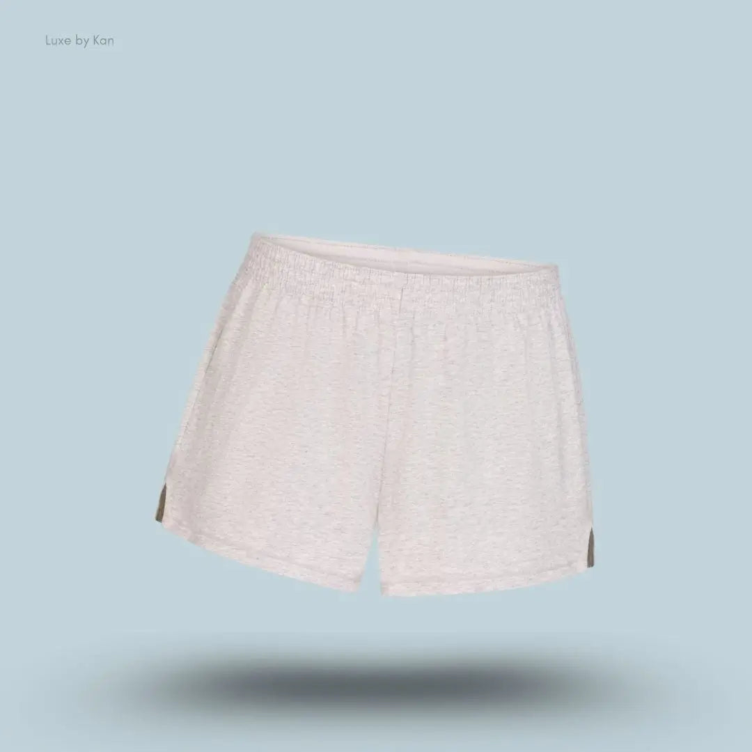 SKIMS Cotton Jersey Loose Short in Light Heather Grey, flat lay on light blue background