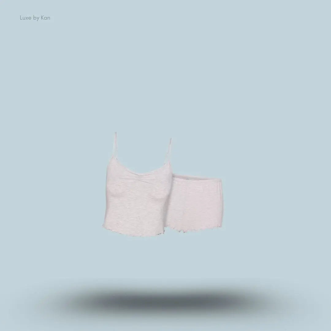 SKIMS Sleep Cami Set in Light Heather Grey, flat lay on light blue background