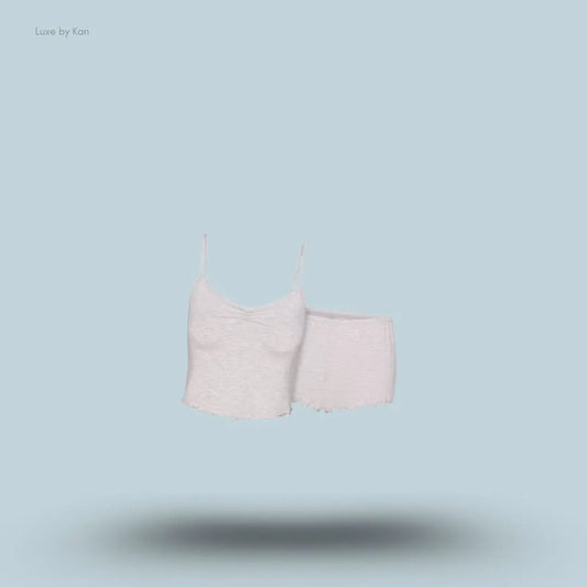 SKIMS Sleep Cami Set in Light Heather Grey, flat lay on light blue background