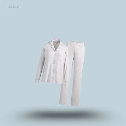 SKIMS Sleep Long Sleeve Button Up Set in Light Heather Grey, flat lay on light blue background