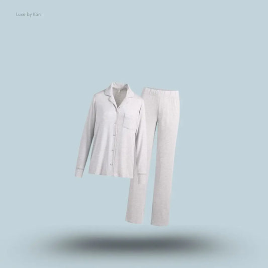 SKIMS Sleep Long Sleeve Button Up Set in Light Heather Grey, flat lay on light blue background