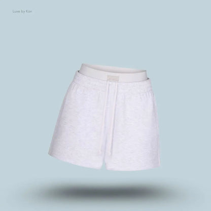 SKIMS Cotton Fleece Double Waistband Short in Light Heather Grey, flat lay on light blue background