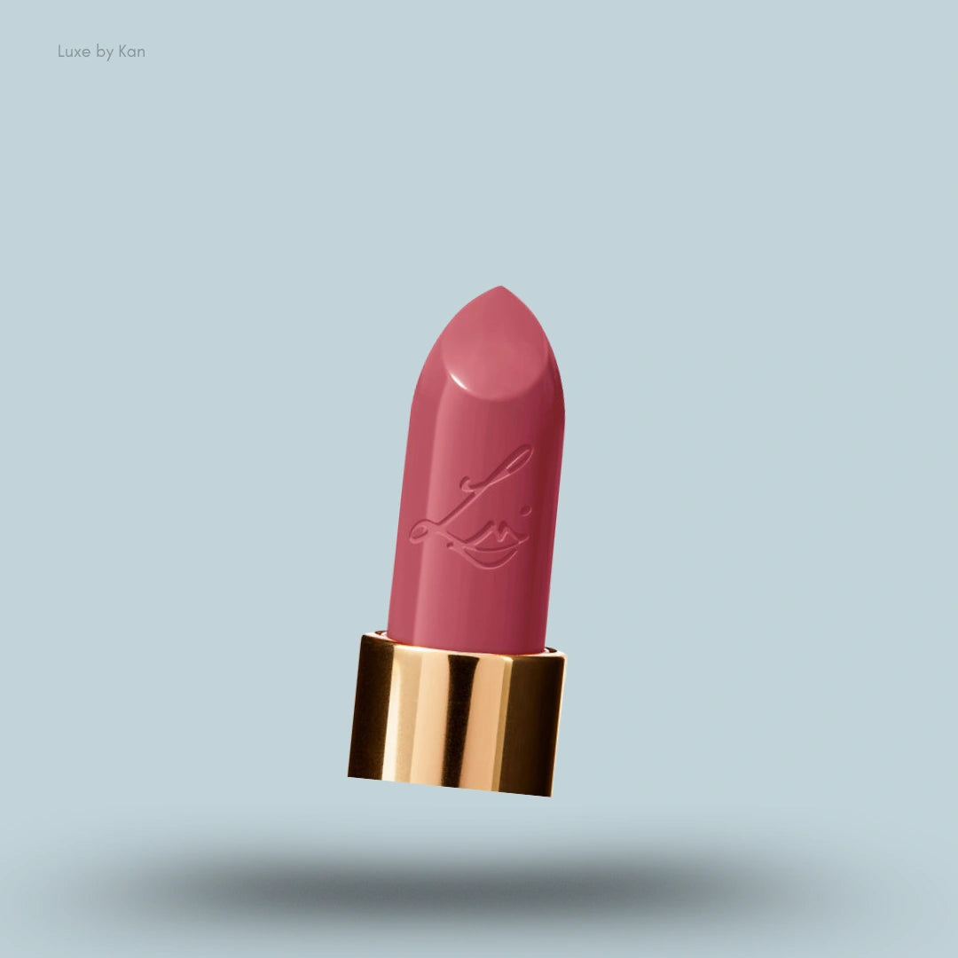 A close-up of the rosy-pink bullet of Lisa Eldridge Luxuriously Lucent Lip Colour in a gold tube.