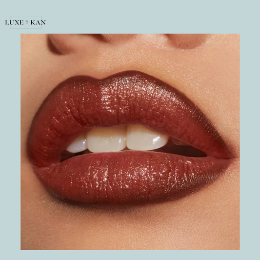 Close-up of luscious, glossy lips in a rich, warm brown shade, showcasing full, perfectly shaped contours against a soft backdrop.