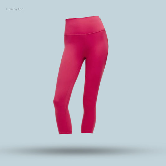 Bright pink leggings with a high waistband, showcasing a modern and stylish athletic design.