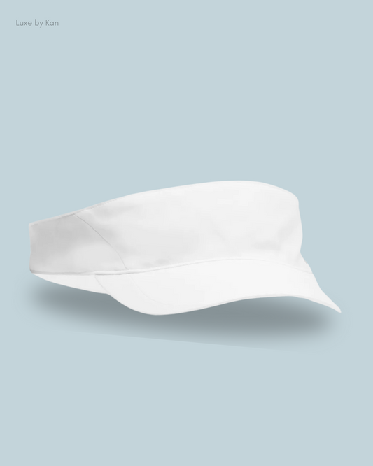 Stylish white visor hat displayed against a soft blue background, showcasing a sleek design ideal for sun protection and casual wear.