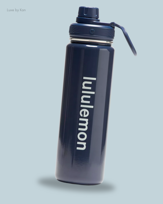 A sleek navy Back to Life Sport Water Bottle 24oz Shine, featuring a sturdy design, flip-top lid, and "lululemon" printed vertically.
