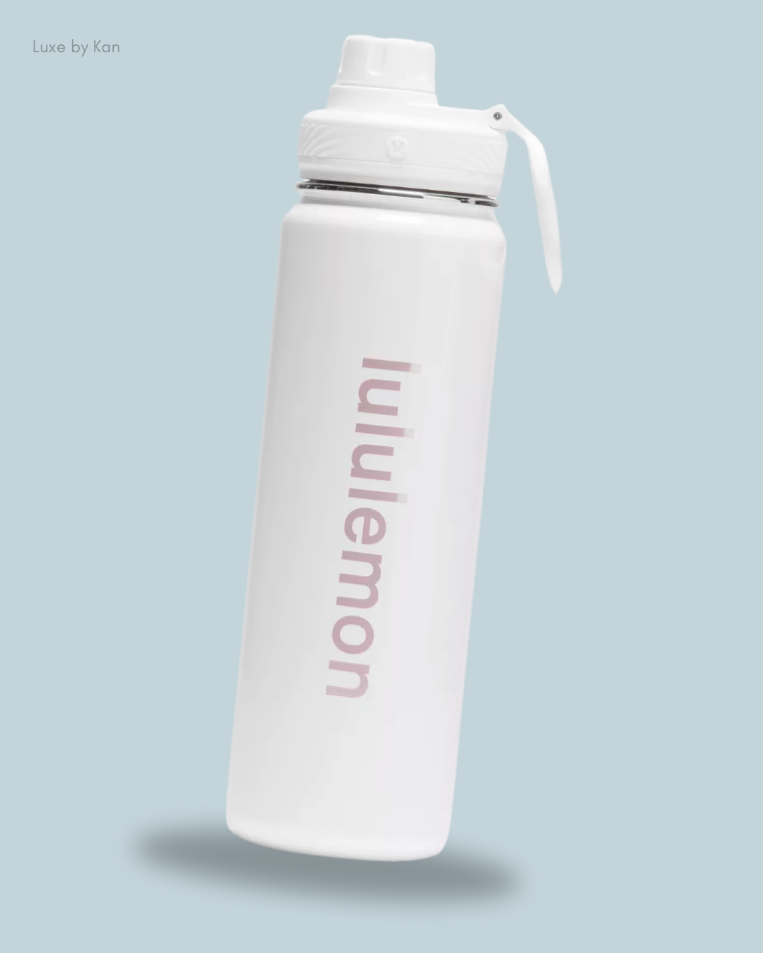 A sleek white water bottle with a subtle 'lululemon' logo and a push-button lid.