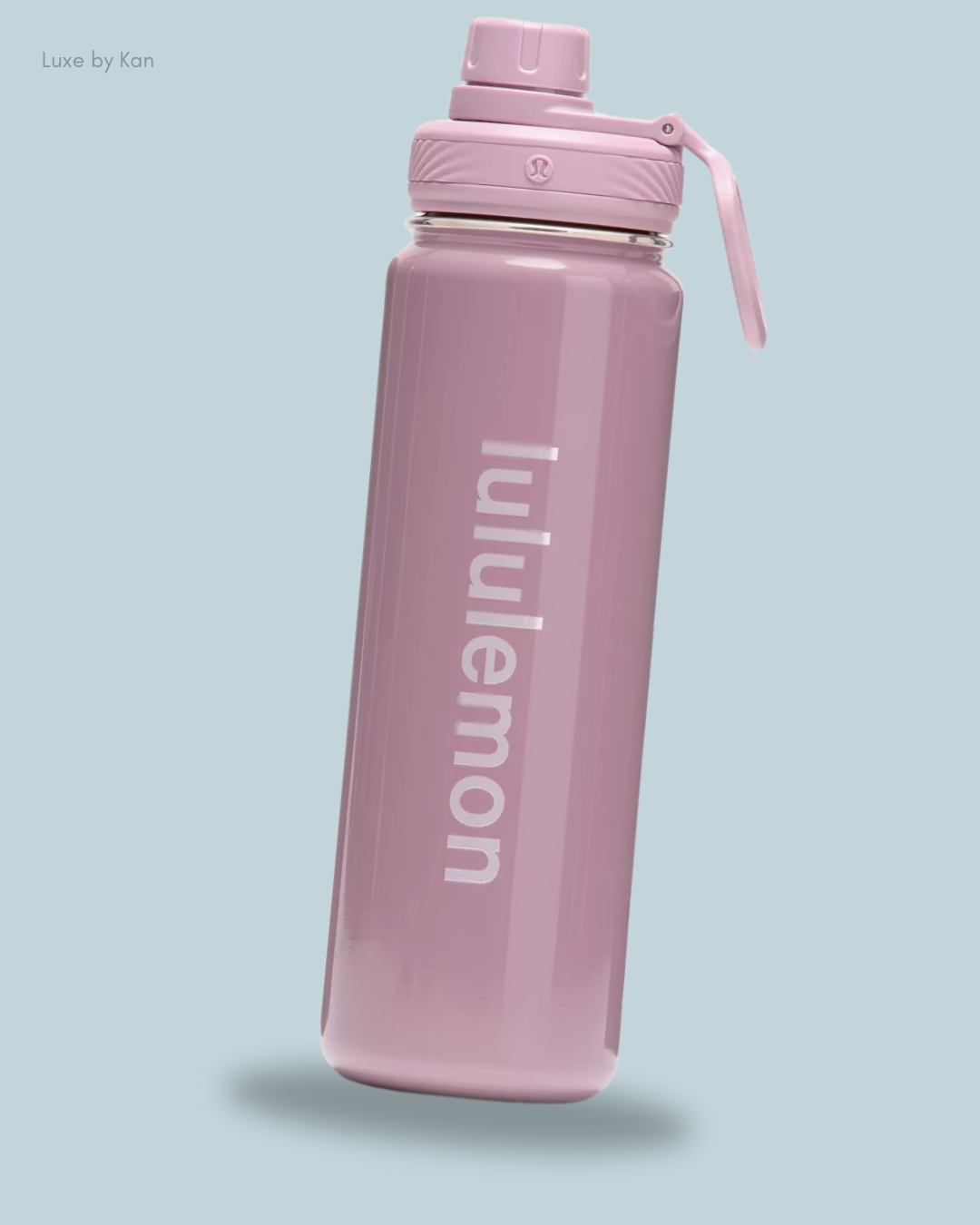 A sleek pink Lululemon Back to Life Sport Water Bottle 24oz Shine, featuring a twist-off lid.