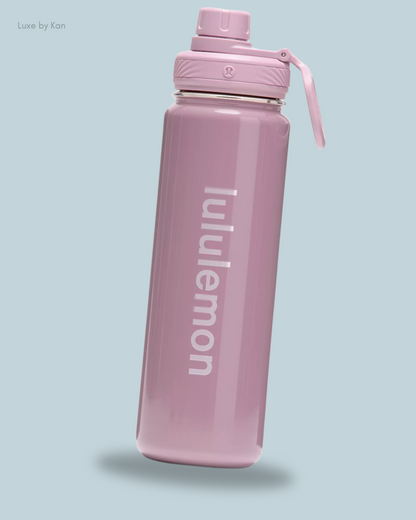 A sleek pink Lululemon Back to Life Sport Water Bottle 24oz Shine, featuring a twist-off lid.