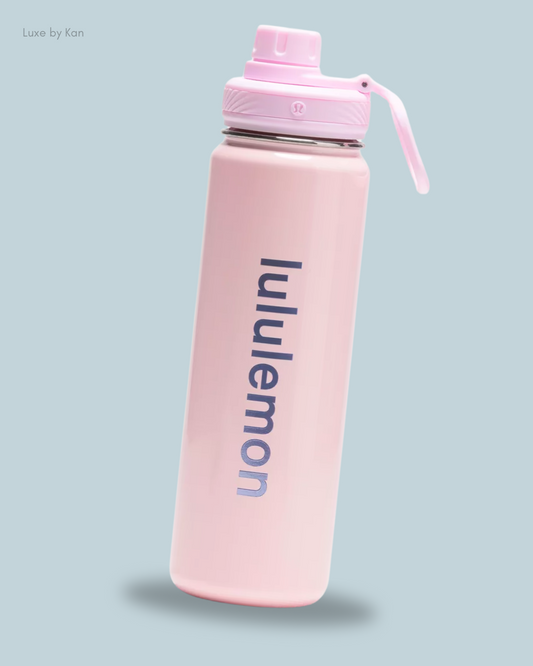 Pink Lululemon water bottle with a purple logo, featuring a cap and a flip-top lid.