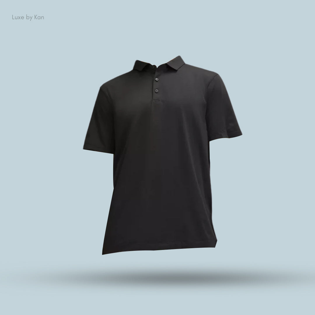 Black polo shirt displayed against a light blue background, featuring a classic collar and button closure, showcasing a sleek design.
