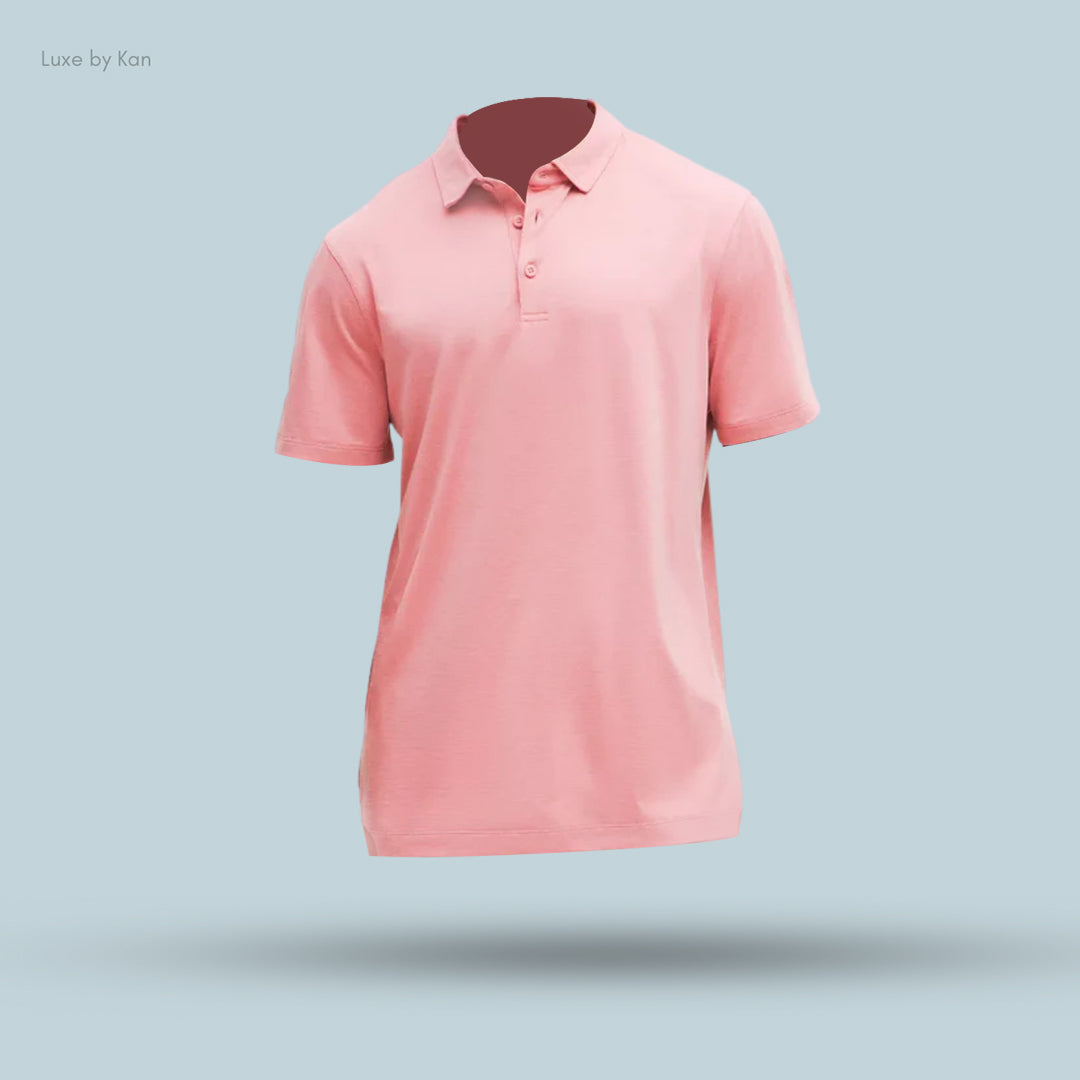 A light pink polo shirt displayed floating against a soft blue background, showcasing its simple, classic design.