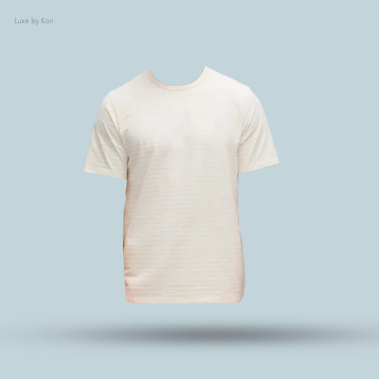 A cream-colored short-sleeved t-shirt displayed against a light blue background with a subtle shadow beneath it.