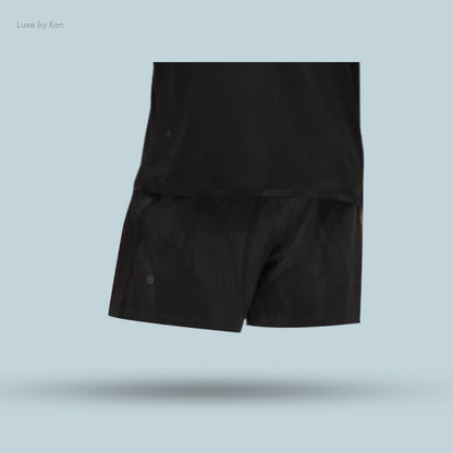 A stylish black athletic outfit consisting of a t-shirt and shorts.