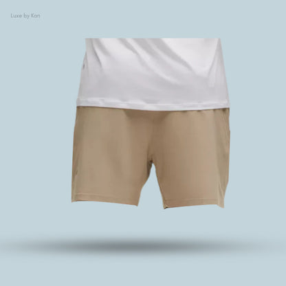 A pair of beige shorts is displayed, partially covered by a white shirt.