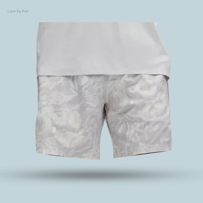 Stylish gray shorts with a subtle abstract pattern, paired with a fitted white shirt.