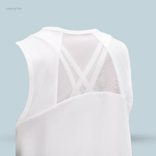 Close-up of a white sculpt cropped tank top cinch with a stylish mesh back and crisscross detailing.