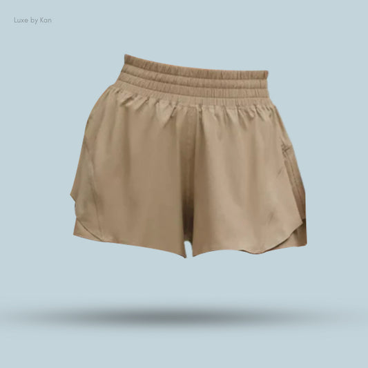 Light brown Lululemon Shake It Out High-Rise Running Shorts 2.5" with a flowing design. Perfect for casual or active wear.

