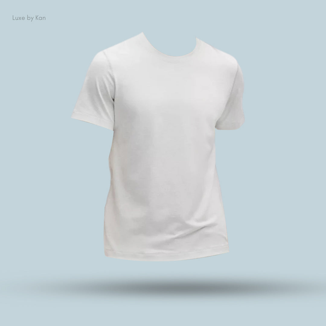 A floating white t-shirt with short sleeves, displayed against a light blue background, showcasing a minimalist design.