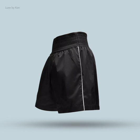 Black Lululemon Stretch Satin Nylon Super-High-Rise 5" Shorts, featuring an elastic waistband and a white side stripe.