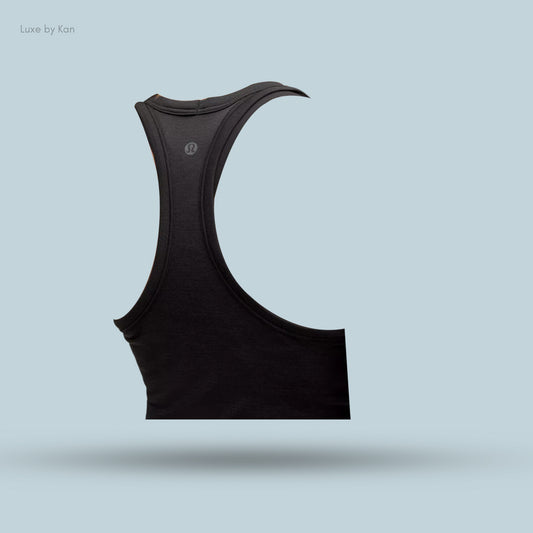Black athletic tank top displayed against a light blue background, featuring a sleek design and the Lululemon logo.
