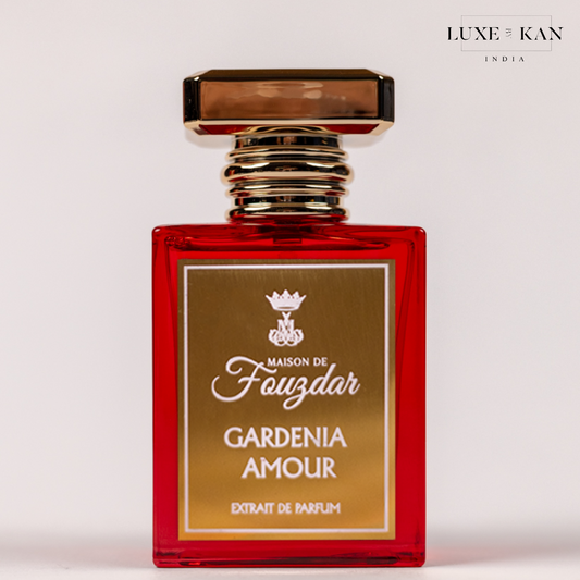 "Gardenia Amour" perfume bottle by Maison de Fouzdar, featuring a striking red design and gold accents.