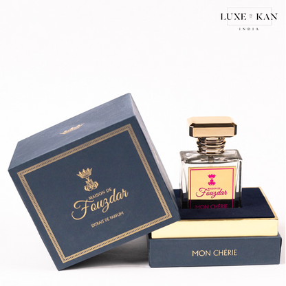 Elegant perfume bottle labeled "Mon Chérie" in a stylish blue and gold box, half-open showcasing its luxurious packaging.