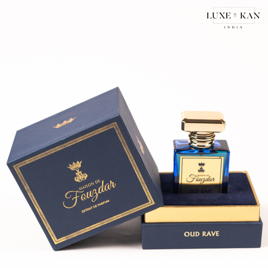 Luxurious perfume bottle of "Maison de Fauzdar - oud rave" displayed elegantly in its navy blue box, adorned with gold accents.
