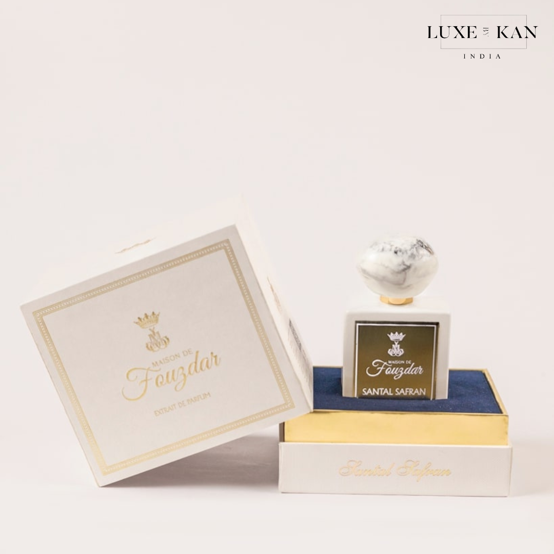 Maison de fouzdar santal safran perfume bottle in a luxury box, showcasing a white and gold design with a decorative cap.