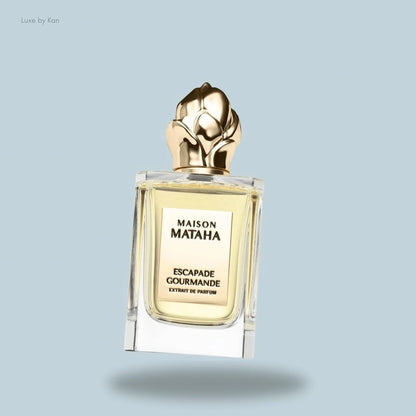 Maison Mataha Escapade Gourmande, a square glass bottle with a golden flower-shaped cap.