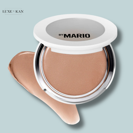 A compact of by Mario cream foundation with a light brown shade, next to a swatch.