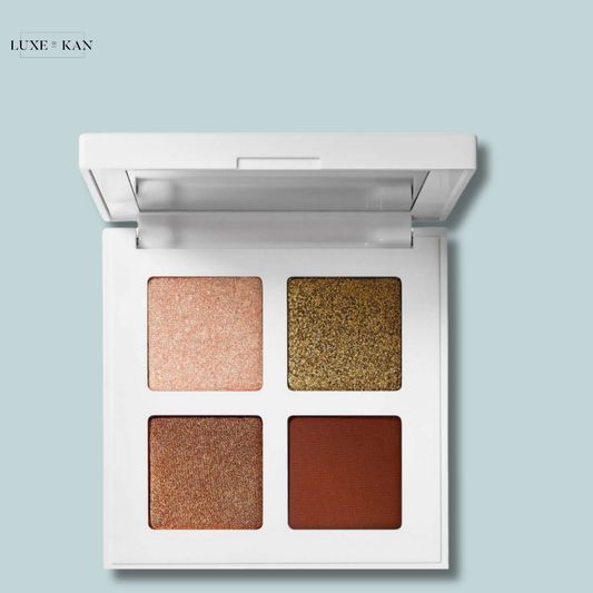 Makeup by mario glam quads eyeshadow palette featuring four shades: light pink shimmer, gold glitter, deep brown shimmer, and matte reddish-brown.