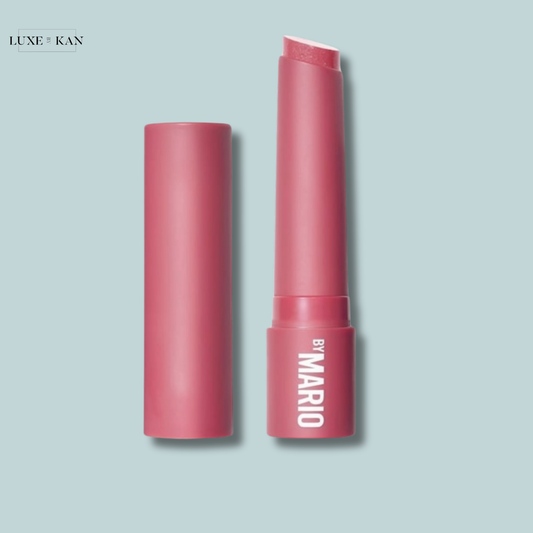 Pink lip balm stick and cap, branded "Makeup by Mario".