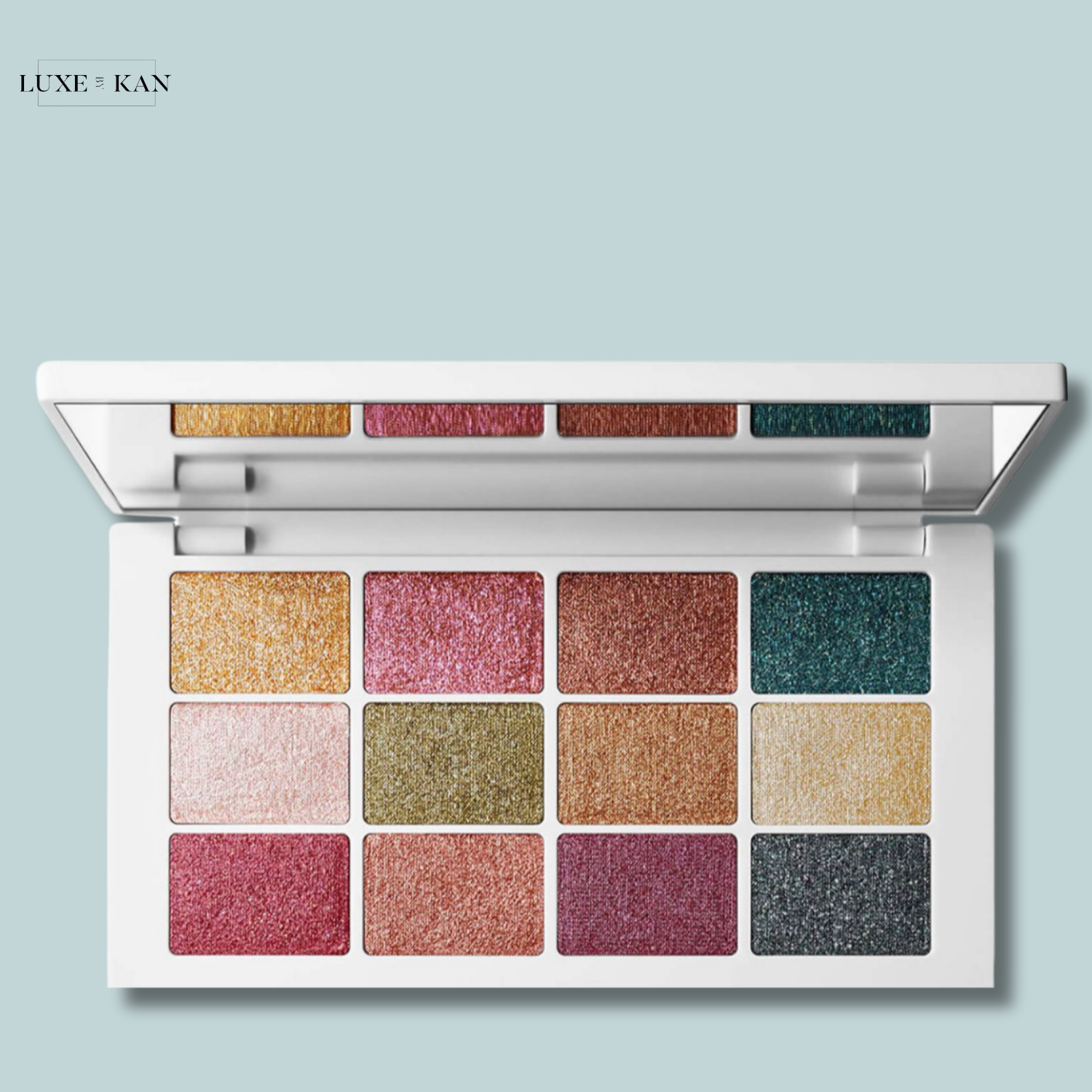 Makeup by mario master metallics eyeshadow palette featuring 12 shimmering eyeshadow shades in pinks, golds, greens, and blues, housed in a sleek white case.