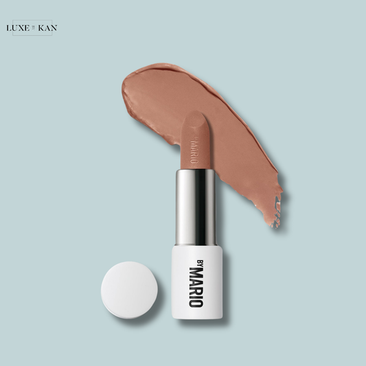 Makeup by Mario Ultra Suede Lipstick placed next to a swatch of the same shade, with a white cap beside it.