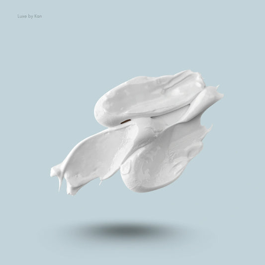 A swirl of thick, white cream, likely Marvis Whitening Mint Toothpaste, on a pale blue background.