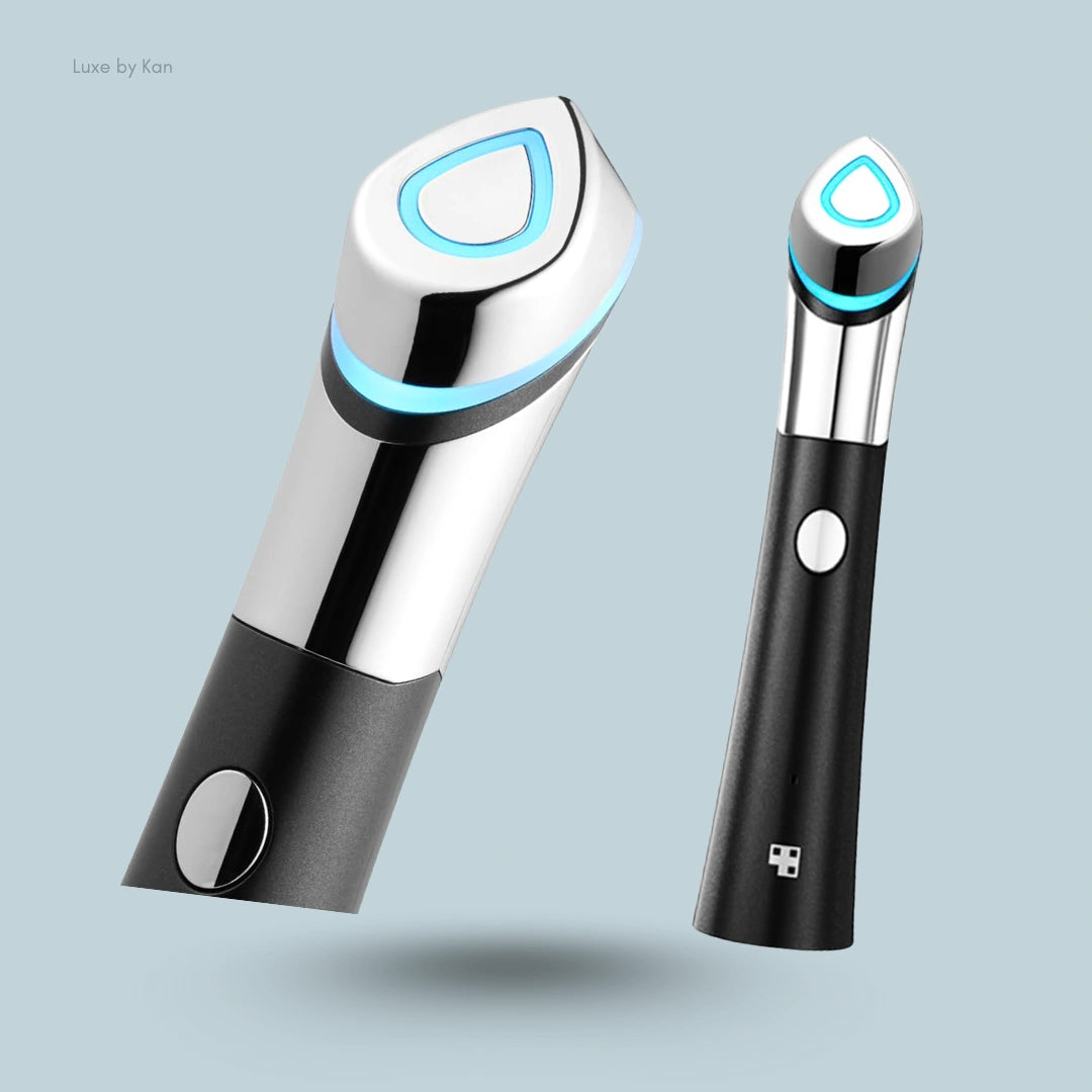 Two Medicube Age-R Booster-H devices displayed with chrome and black finish details, highlighting illuminated blue button on each device.