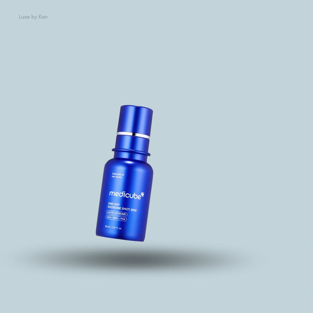 A vibrant blue bottle of Medicube One Day Exosome Shot Pore Ampoule 2000 over a light blue background with a soft shadow underneath.