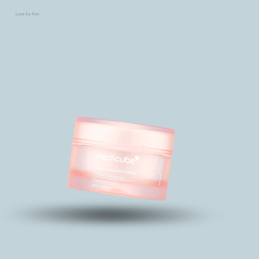 A pink jar of Medicube Triple Collagen Cream floats over a light blue background with a soft shadow.