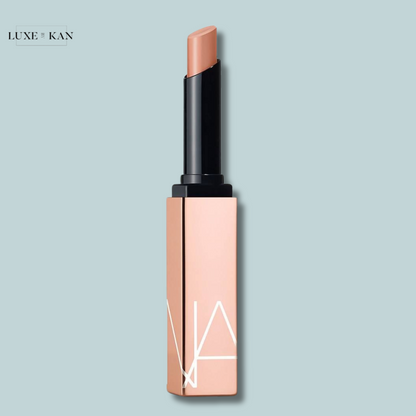 NARS afterglow lipstick in a sleek, modern case with a black top and subtle geometric design.