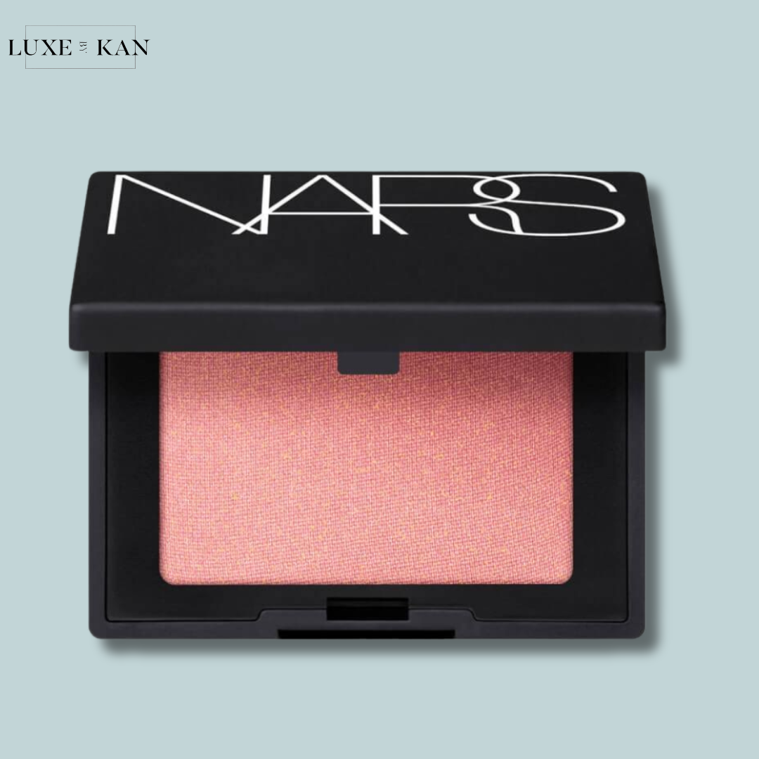 Close-up of a NARS mini blush in a sleek black compact with a soft pink shade.