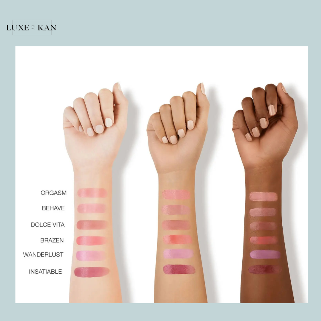 Arm swatches of five lip colors on three skin tones, labeled "Orgasm," "Behave," "Dolce Vita," "Brazen," "Wanderlust," and "Insatiable."