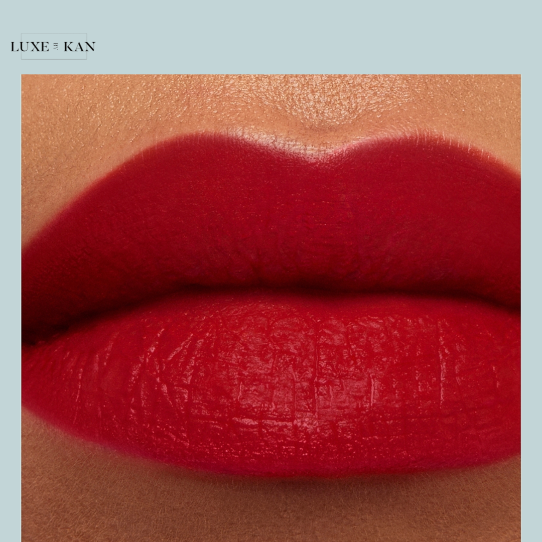 Close-up of perfectly shaped lips coated in bold red lipstick, showcasing a smooth matte finish.