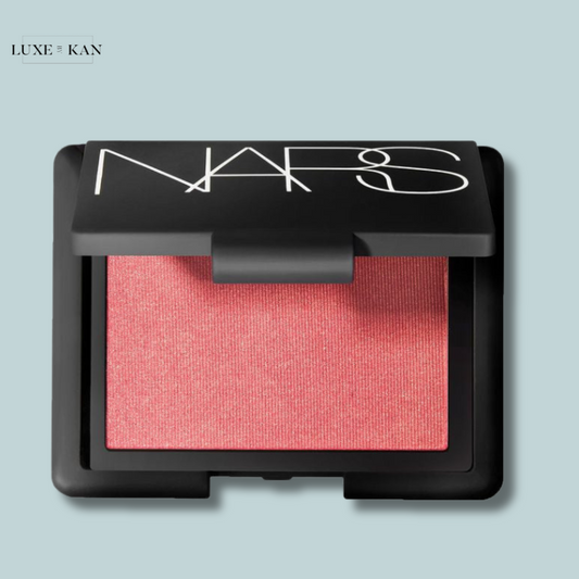 A square NARS blush compact with a bright pink shimmery powder inside.
