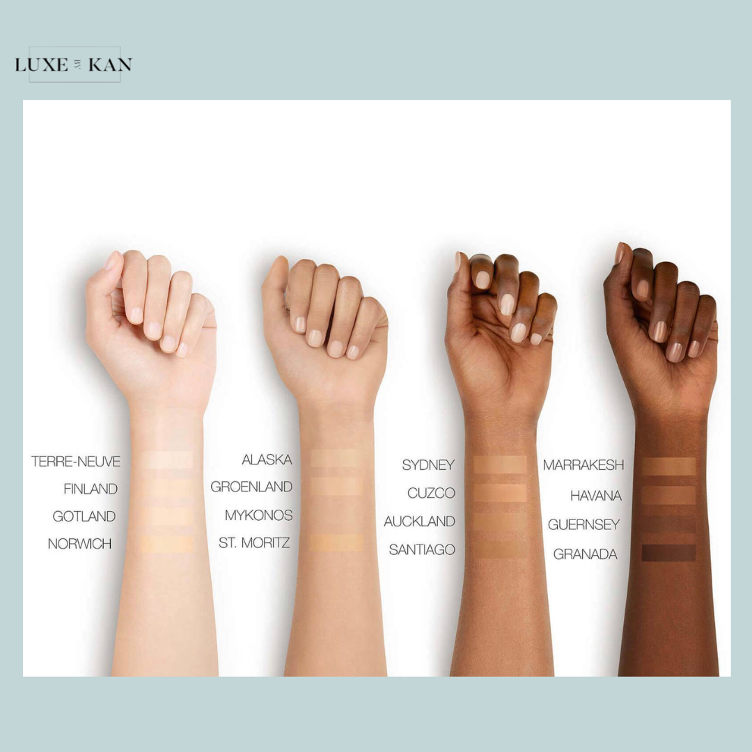 A display of diverse skin tones on wrists, featuring swatches for various shades labeled with names like Sydney and Marrakesh.