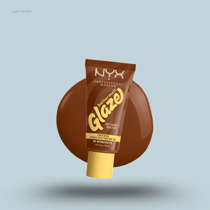 NYX Professional Makeup Buttermelt Glaze Skin Tint SPF 30 tube and swatch on blue background — LBK