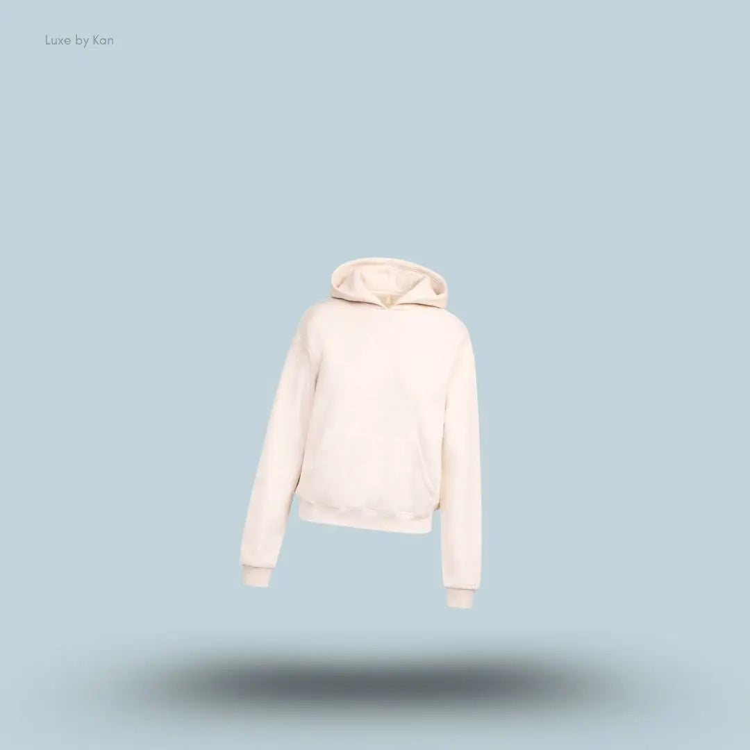 SKIMS Cotton Fleece Classic Hoodie in Oatmeal Heather, flat lay on light blue background