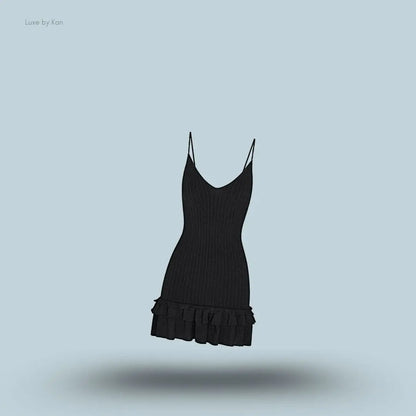 SKIMS Sheer Knit Ruffle Dress in Onyx, flat lay on light blue background